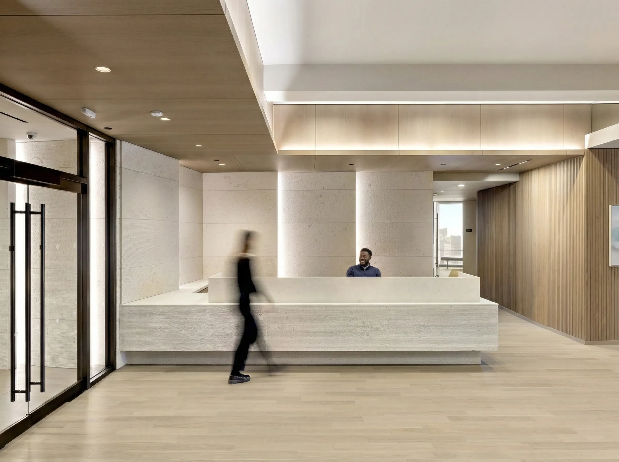 Textured Biancone stone forming a reception desk and surrounding wall surfaces